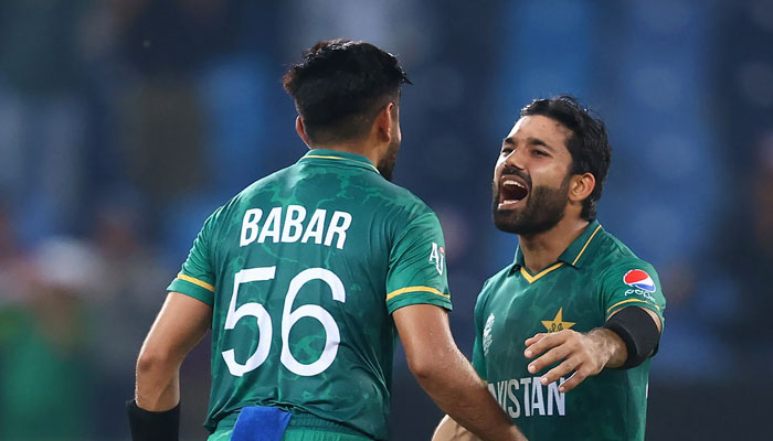Pakistan openers Babar Azam (left) and Mohammad Rizwan move forward to hug after a massive innings in T20 World Cup 2021. — ICC