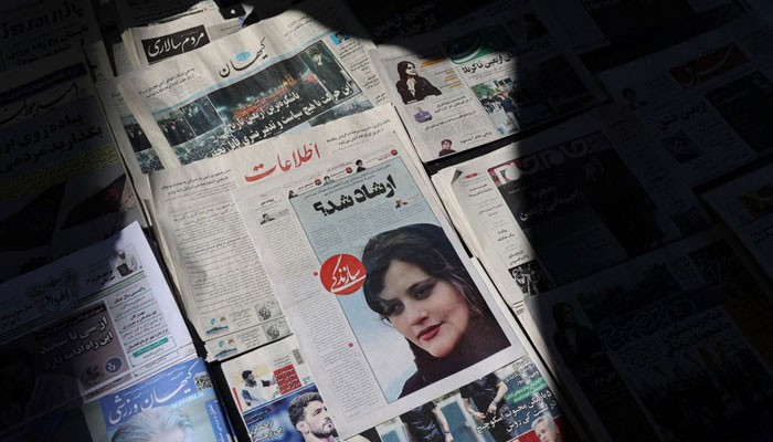 A newspaper with a cover picture of Mahsa Amini, a woman who died after being arrested by the Islamic republics morality police is seen in Tehran, Iran September 18, 2022. — Reuters