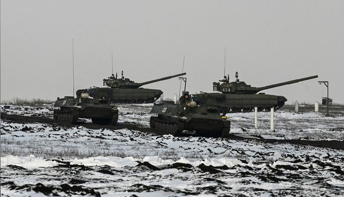 Russian army service members drive MT-LB multi-purpose amphibious armoured carriers past tanks during drills at the Kuzminsky range in the southern Rostov region, Russia January 26, 2022. — Reuters