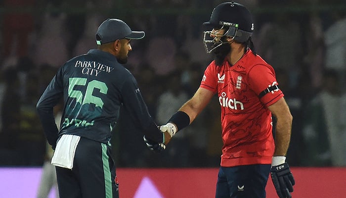 Englands captain Moeen Ali (R) shakes hands with Pakistans captain Babar Azam after their victory at the end of the first Twenty20 international cricket match between Pakistan and England at the National Cricket Stadium in Karachi on September 20, 2022. — AFP