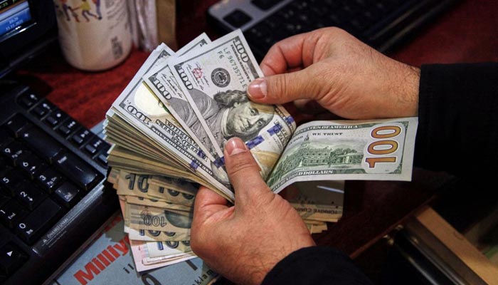 A money changer counts U.S. dollar banknotes at a currency exchange office in Ankara, Turkey November 11, 2021. — Reuters/File