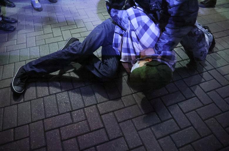 Russian police officers detain a person during an unsanctioned rally, after opposition activists called for street protests against the mobilization of reservists ordered by President Vladimir Putin, in Moscow, Russia September 21.