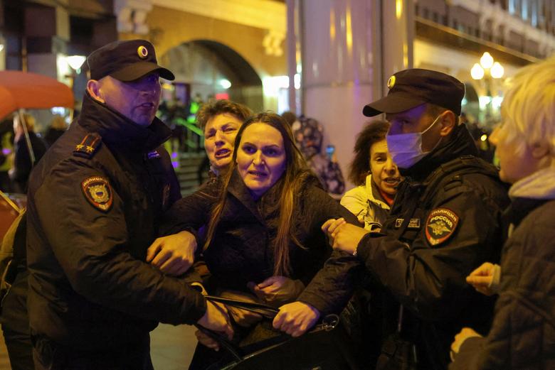 Russian police officers detain a person during an unsanctioned rally, after opposition activists called for street protests against the mobilization of reservists ordered by President Vladimir Putin, in Moscow, September 21.