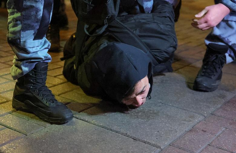 Russian police officers detain a person during an unsanctioned rally, after opposition activists called for street protests against the mobilization of reservists ordered by President Vladimir Putin, in Moscow, September 21.