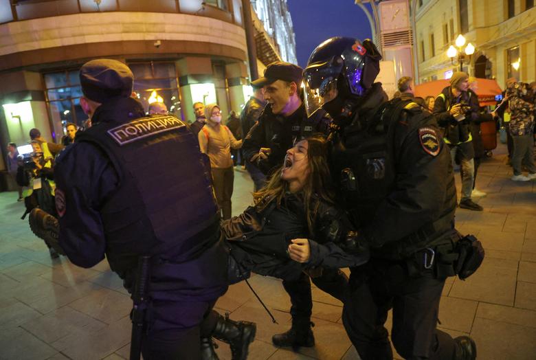 Russian police officers detain a protester during an unsanctioned rally, after opposition activists called for street protests against the mobilization of reservists ordered by President Vladimir Putin, in Moscow, September 21.