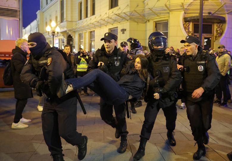 Russian law enforcement officers detain a person during an unsanctioned rally, after opposition activists called for street protests against the mobilisation of reservists ordered by President Vladimir Putin, in Moscow, Russia.