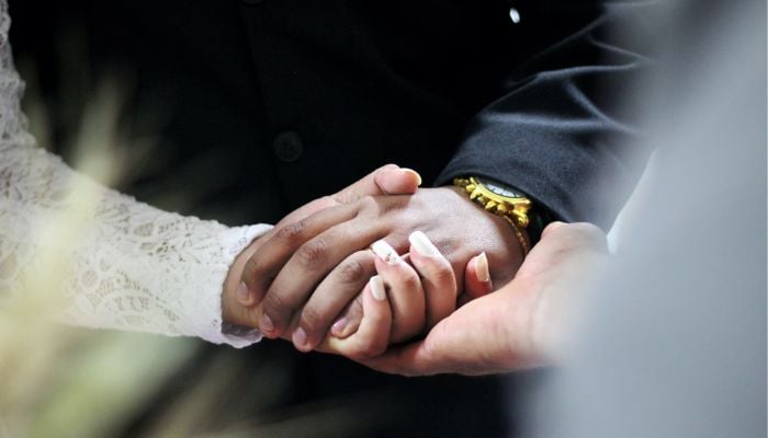 Wedding couples hands. — Unsplash