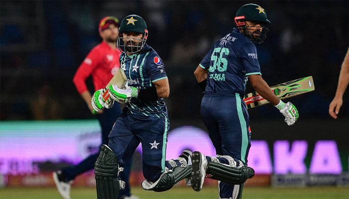 Pakistan´s captain Babar Azam (R) and teammate Mohammad Rizwan (L) run between the wicket during the second Twenty20 international cricket match between Pakistan and England at the National Cricket Stadium in Karachi on September 22, 2022. —AFP/Asif HASSAN