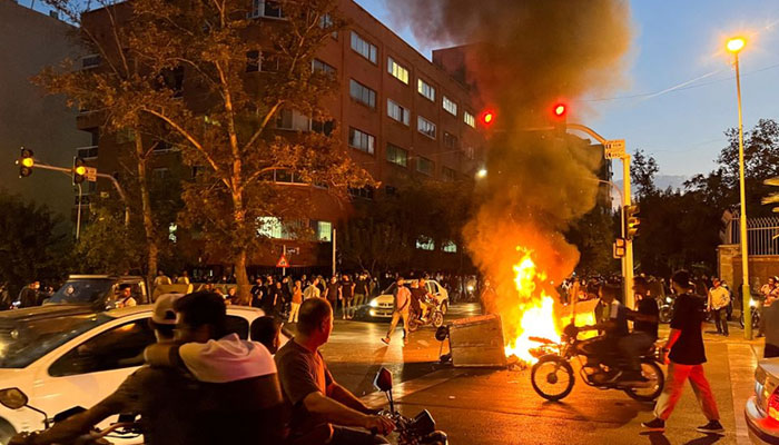 A police motorcycle burns during a protest over the death of Mahsa Amini, a woman who died after being arrested by the Islamic republics morality police, in Tehran, Iran September 19, 2022. — Reuters