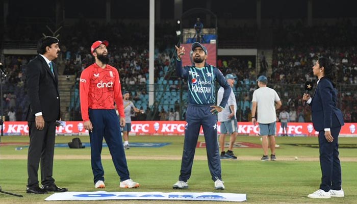 Englands stand-in skipper Moeen Ali and Pakistan all-format captain Babar Azam stand for the toss at the National Stadium Karachi for the third of the seven-match T20I series on September 23, 2022. — PCB