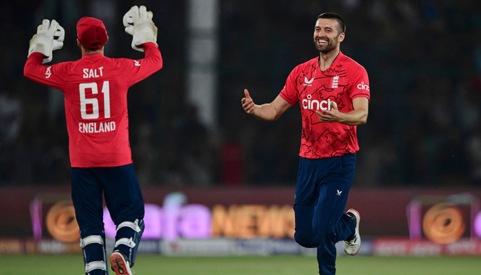 Englands Mark Wood (R) celebrates with teammates after taking the wicket of Pakistans Haider Ali (not pictured) during the third Twenty20 international cricket match between Pakistan and England at the National Cricket Stadium in Karachi on September 23, 2022. — AFP