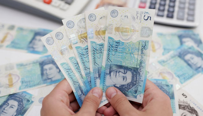 Woman holds British pound banknotes in this illustration taken May 30, 2022. — Reuters