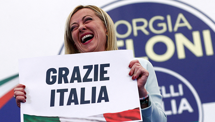 Leader of Brothers of Italy Giorgia Meloni holds a sign at the partys election night headquarters, in Rome, Italy September 26, 2022. — Reuters