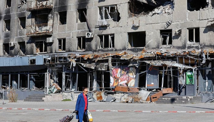 A local resident walks past an apartment block damaged in the course of Russia-Ukraine conflict in Mariupol, Ukraine September 25, 2022. — Reuters