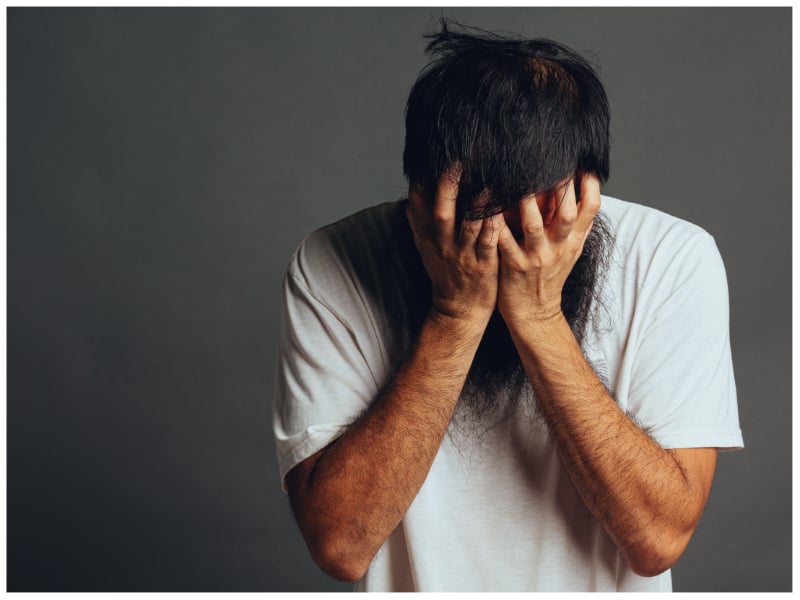 Representational image of a man burying his face in his hands. — Freepik