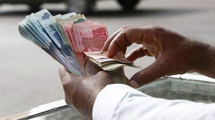 What led to rupee's devaluation despite IMF loan?