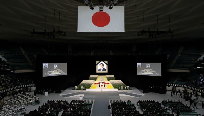 A portrait of Shinzo Abe hangs above the stage during the state funeral for Japans former prime minister Shinzo Abe on September 27, 2022 at the Budokan in Tokyo, Japan. Several current and former heads of state visited Japan for the state funeral of Abe, who was assassinated in July while campaigning on a street. — Reuters