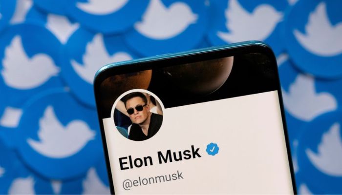 Elon Musks Twitter profile is seen on a smartphone placed on printed Twitter logos in this picture illustration taken April 28, 2022.— Reuters