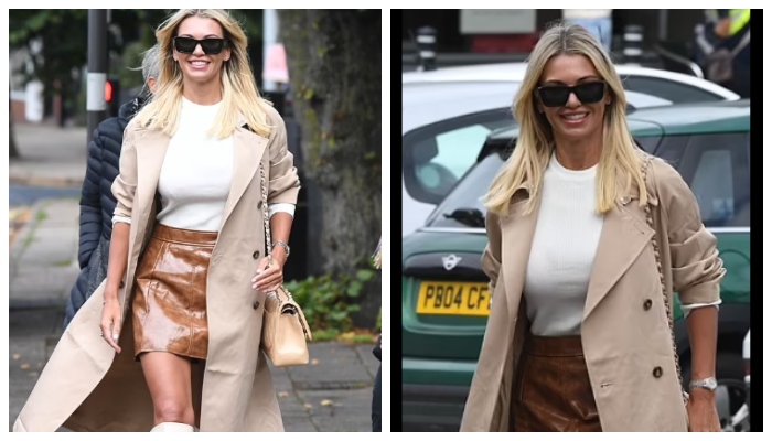 Christine McGuinness cuts a stylish figure in beige coat and brown leather mini skirt