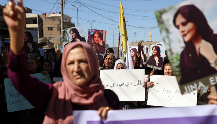 Women carry banners during a protest over the death of 22-year-old Kurdish woman Mahsa Amini in Iran, in the Kurdish-controlled city of Qamishli, northeastern Syria September 26, 2022. — Reuters