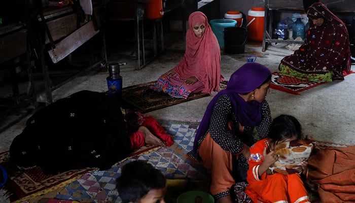 Women displaced because of the floods, offer afternoon prayers while they take refuge in a school, following rains and floods during the monsoon season, in Karachi, Pakistan September 23, 2022. — Reuters