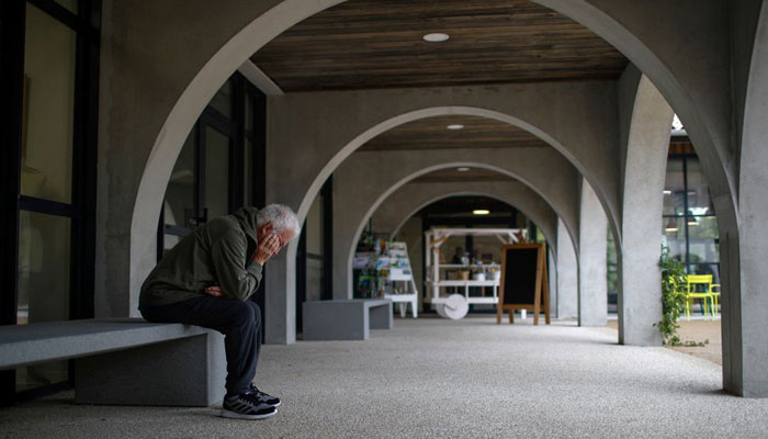 An Alzheimers patient rests on a bench after a walk at the Village Landais Alzheimer site in Dax, France, September 24, 2020. Picture taken on September 24, 2020. — Reuters