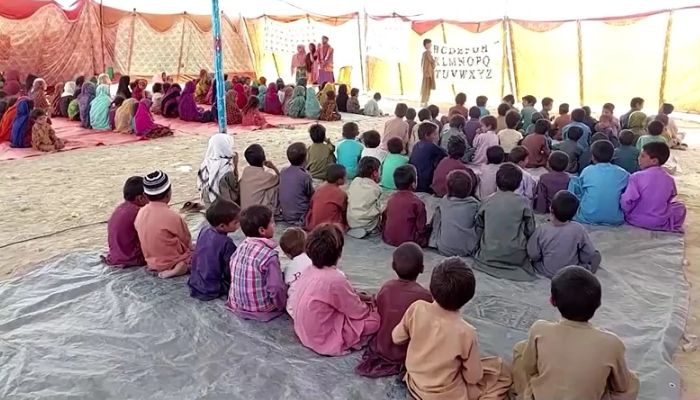 Flood-affected displaced children attend class in a tent. — Screengrab via Reuters video
