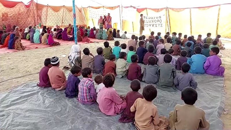 Flood-affected displaced children attend class in a tent. — Screengrab via Reuters video