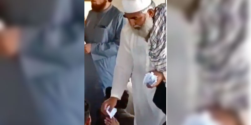 A still from the video provided by the politician of his workers collecting paper tokens. — Geo Fact-Check