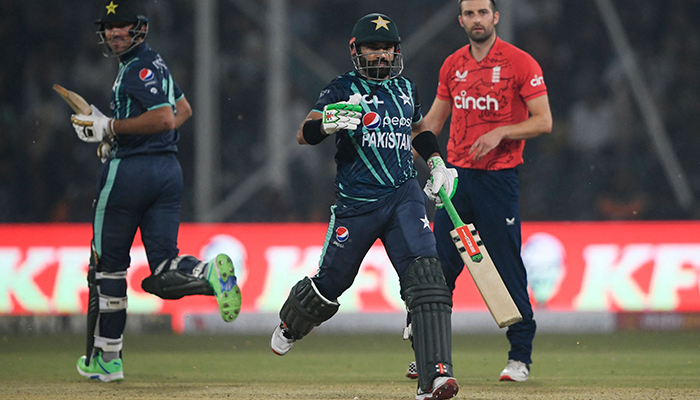 Pakistan´s Mohammad Rizwan (C) and Mohammad Wasim (L) run between the wickets during the fifth Twenty20 international cricket match between Pakistan and England at the Gaddafi Cricket Stadium in Lahore on September 28, 2022. — AFP