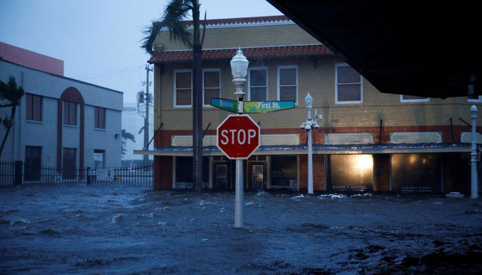 A flooded street is seen in downtown as Hurricane Ian makes landfall in southwestern Florida, in Fort Myers, Florida, US,Gusts from Hurricane Ian begin to knock down small trees and palm fronds in a hotel parking lot in Sarasota, Florida, US September 28, 2022. September 28, 2022. — Reuters