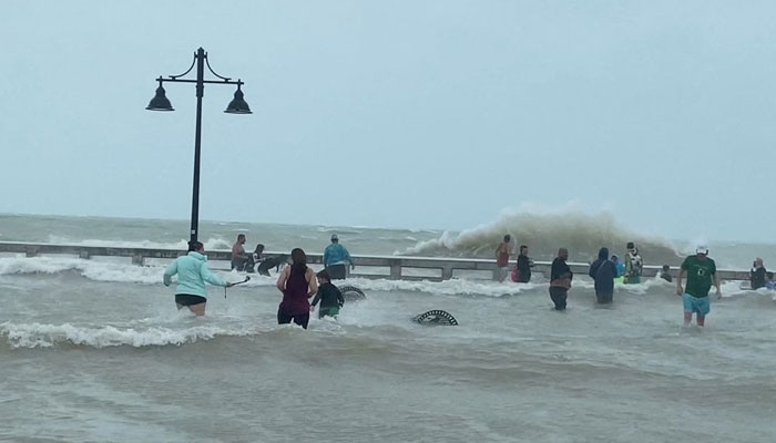 People gather at Key West pier as Hurricane Ian approaches, in Key West, Florida, September 27, 2022. — Reuters