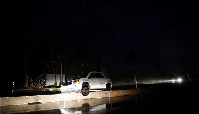 A car is stranded at the median blockade of a street as Hurricane Ian makes landfall in southwestern Florida, in Fort Myers, Florida, US September 28, 2022. — Reuters