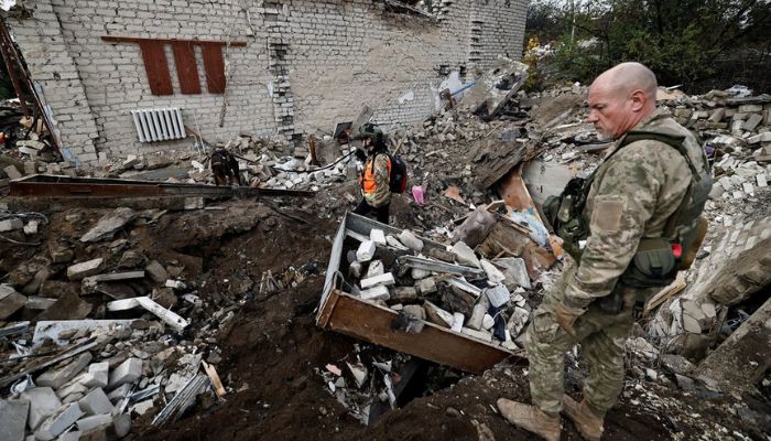Firefighters and Ukrainian army soldiers search for bodies of people killed during a Russian attack, among the remains of a building beside a TV tower, in the recently liberated town of Izium, Kharkiv region, Ukraine September 28, 2022.— Reuters