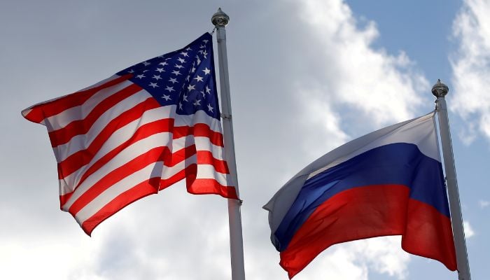 Russian and U.S. state flags fly near a factory in Vsevolozhsk, Leningrad Region, Russia March 27, 2019. — REUTERS