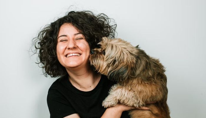 A woman with her pet dog.— Unsplash