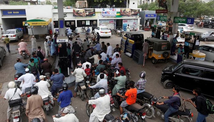 Customers gather to buy petrol at a petrol station in Karachi, Pakistan July 26, 2017. — Reuters