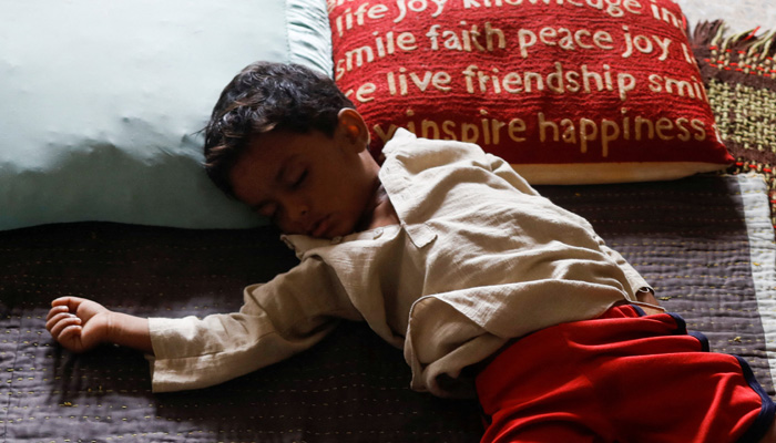 A boy displaced because of the floods, sleeps as his family takes refuge in a school, following rains and floods during the monsoon season, in Karachi, Pakistan September 23, 2022. —Reuters