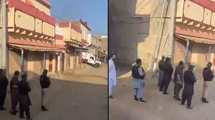 Police personnel stand on guard near Taiser Town, situated along Super Highway, in Karachi, on October 1, 2022. — Twitter