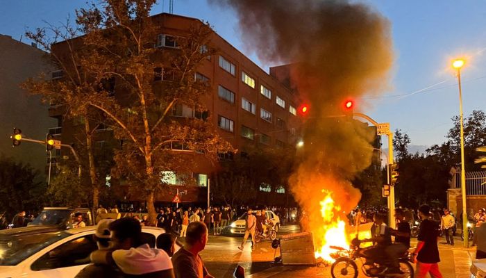 A police motorcycle burns during a protest over the death of Mahsa Amini, a woman who died after being arrested by the Islamic republics morality police, in Tehran, Iran September 19, 2022.— Reuters