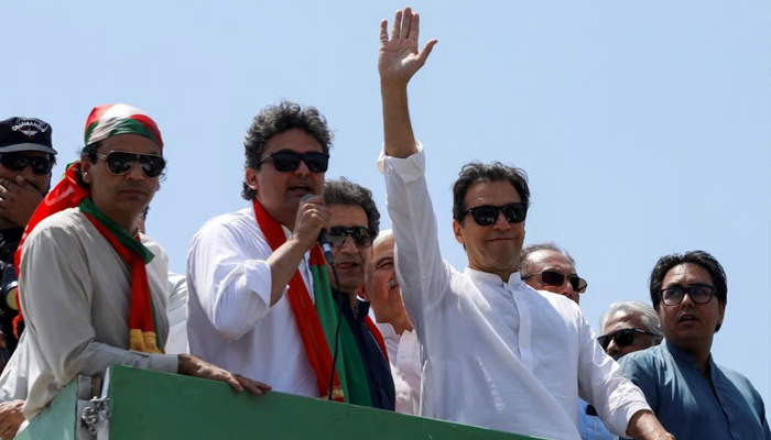 Ousted Pakistani Prime Minister Imran Khan gestures as he travels on a vehicle to lead a protest march to Islamabad. — Reuters