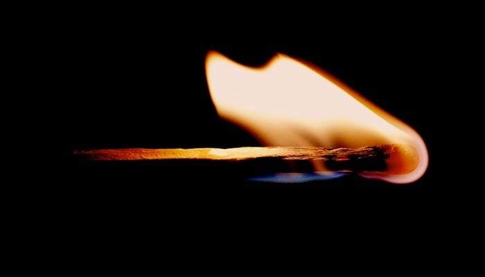A representational image of a burning match stick. — Unsplash