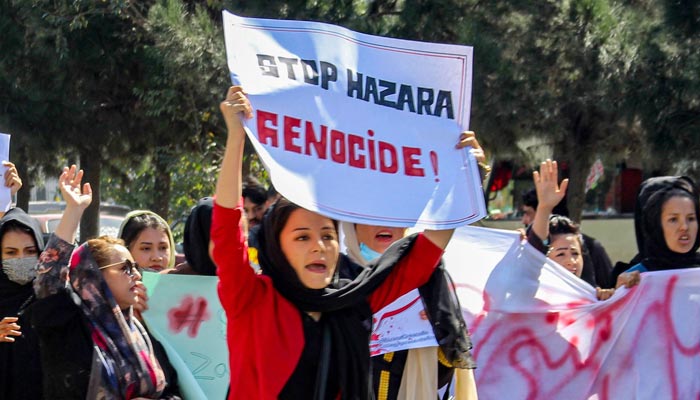 Afghan women display placards and chant slogans during a protest they call Stop Hazara genocide a day after a suicide bomb attack at Dasht-e-Barchi learning centre, in Kabul on October 1,
