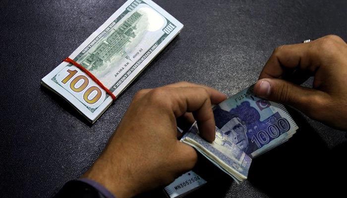 A currency trader counts Pakistani Rupee notes as he prepares an exchange of U.S dollars in Islamabad, Pakistan December 11, 2017. — Reuters/File