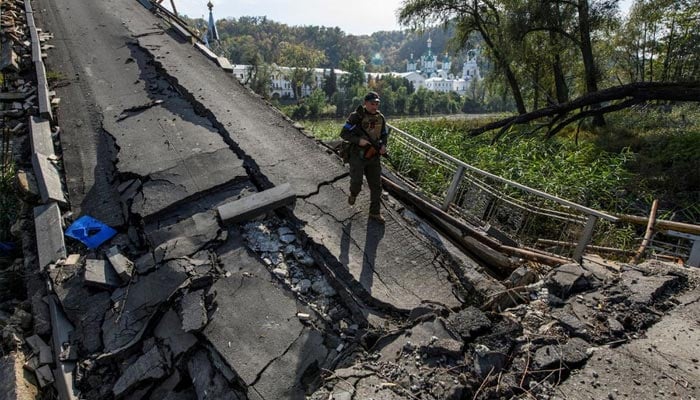 A service member of Ukraines National Guard walks on a bridge over the Siverskyi Donets river destroyed during Russias attack on Ukraine, in the town of Sviatohirsk, Donetsk region, Ukraine October 1, 2022. — Reuters/File