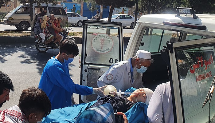 Relatives and medical staff shift a wounded girl from an ambulance outside a hospital in Kabul on September 30, 2022, following a blast at a learning centre in the Dasht-e-Barchi area of Afghanistan´s capital. — AFP