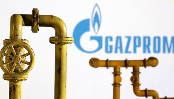 Model of natural gas pipeline and Gazprom logo, July 18, 2022. — Reuters
