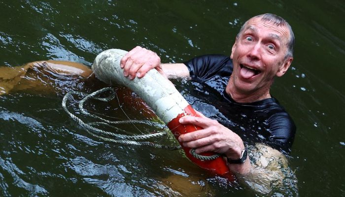 Swedish geneticist Svante Paabo, who won the 2022 Nobel Prize in Physiology or Medicine for discoveries that underpin our understanding of how modern day humans evolved from extinct ancestors, holds on to a life-saver after being thrown into the water by co-workers, at the Max-Planck Institute for evolutionary anthropology in Leipzig, Germany, October 3, 2022.— Reuters