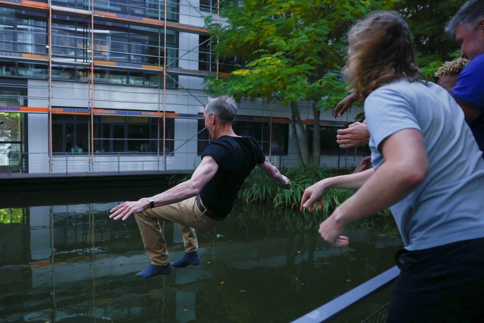 Swedish geneticist Svante Paabo, who won the 2022 Nobel Prize in Physiology or Medicine for discoveries that underpin our understanding of how modern day humans evolved from extinct ancestors, is thrown into water by co-workers at the Max-Planck Institute for evolutionary anthropology in Leipzig, Germany, October 3, 2022. —  Reuters