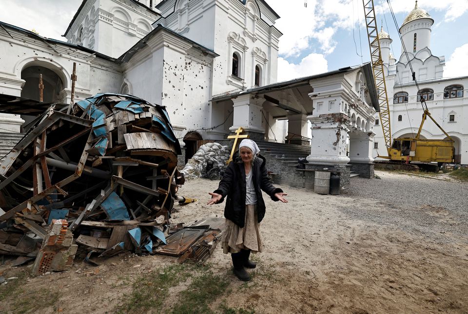 Lyudmiyla, 64, who sheltered for weeks in the basement of the Lavra monastery complex that belongs to the Ukrainian Orthodox Church of the Moscow Patriarchate, with scores of other Ukrainians during fierce battles between Russian troops and Ukrainian forces reacts while she speaks to journalist outside the church in Svyatohirsk, in Donetsk region, Ukraine, October 3, 2022.